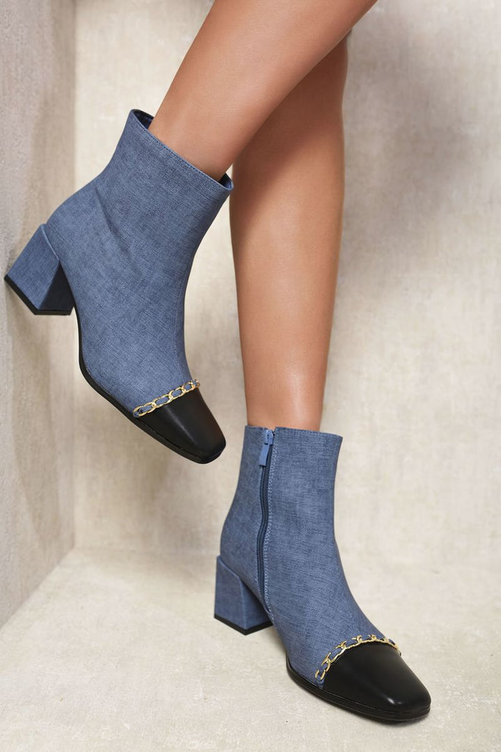 Legs wearing Two Tone Side Zip Block Heel Ankle Boots, showcasing stylish design with a side zip and comfortable block heel for all-day wear.