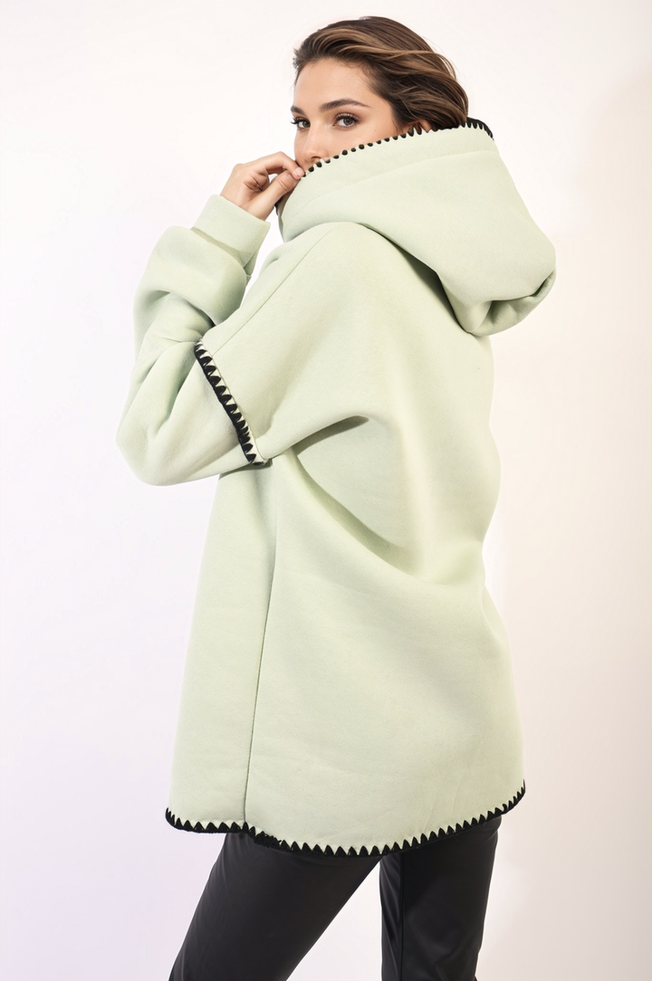 Bella Blanket Stitch Knitted Hoodie with unique stitch detail, worn by a person. Cozy, stylish outerwear perfect for everyday comfort.