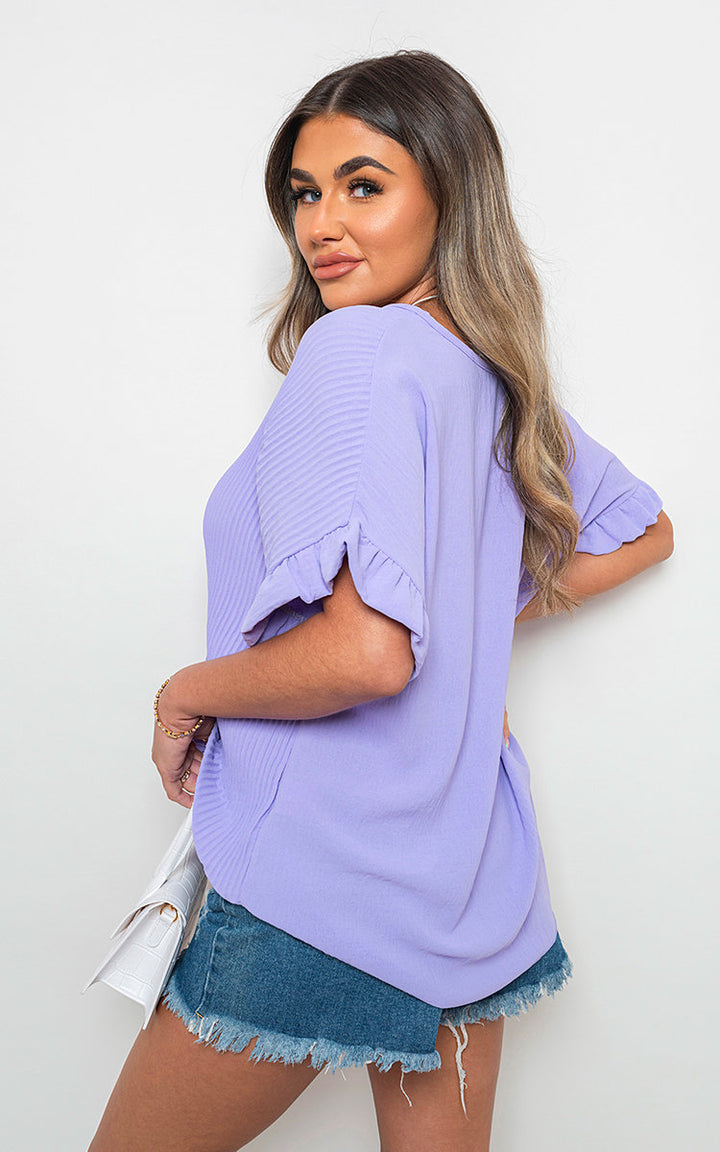 Frill Sleeve Top With Chain showcased on a woman, highlighting the frill sleeves and stylish chain detail, embodying a chic, versatile design from Holiday Clothes UK.