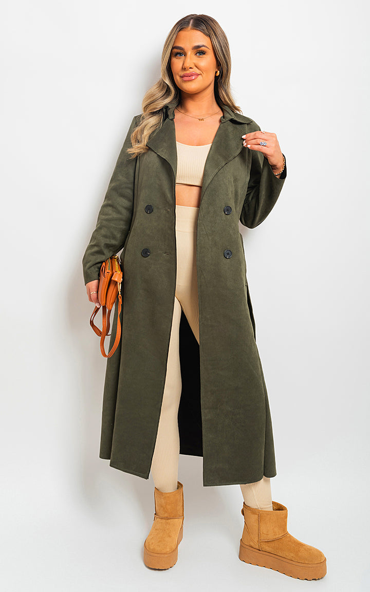 Woman in an Open Front Lapel Neck Longline Trench Coat, holding a purse, wearing platform brown boots.