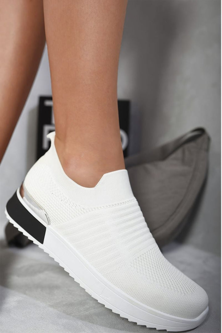 Slip On Sock Wedge Trainers showcase a sleek design, featuring a comfortable sock-like fit ideal for casual outings, emphasizing effortless chic style.