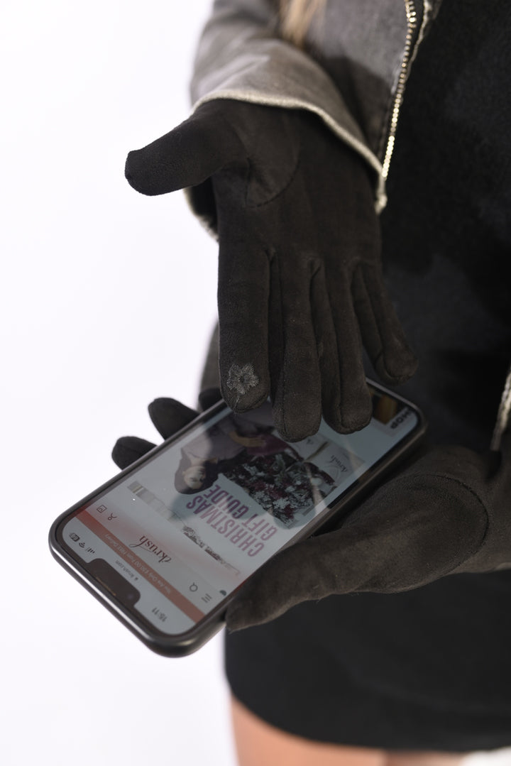 Person wearing Blake Winter Suede Gloves while holding a phone, showcasing the gloves' elegance and functionality for stylish winter wear.