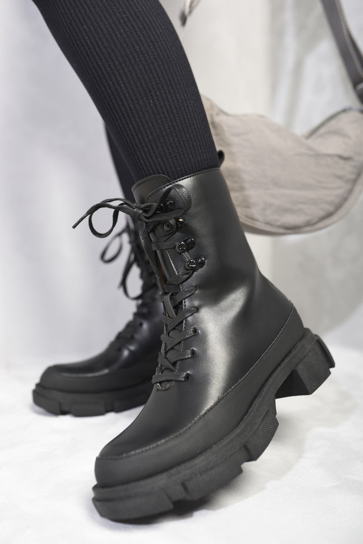 Chunky platform lace-up ankle boots with a modern design, featuring a sturdy build and faux leather material, ideal for stylish, everyday wear.