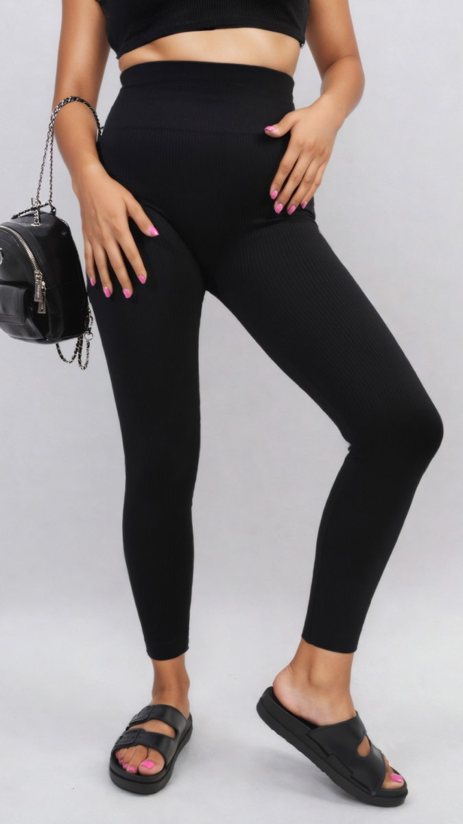 Woman wearing Braylee High Waisted Wide Band Leggings, showcasing their supportive fit and versatile style with a close-up of black sandals and a handbag.