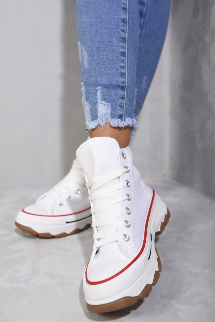 High Top Platform Lace Up Trainers worn by a person, showcasing their stylish high-top design and platform sole, perfect for enhancing casual outfits.