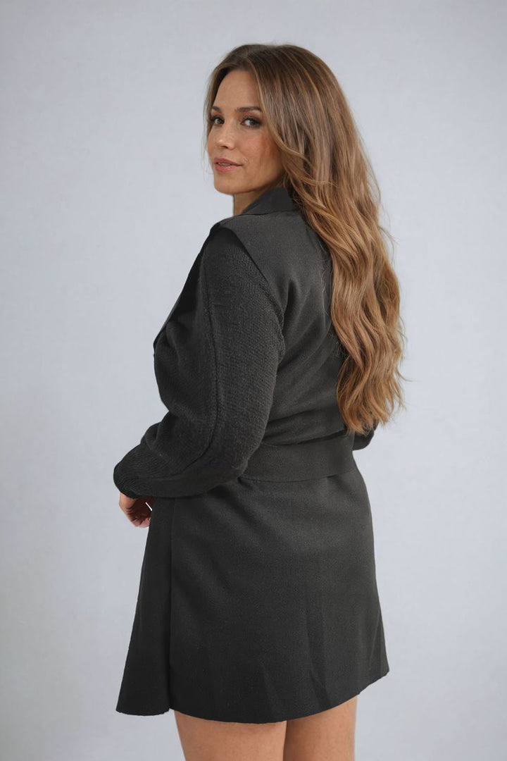 Woman wearing the Wide Lapel Sleeveless Belted Jacket, showcasing its chic silhouette and versatile design. Perfect for layering and stylish holiday outfits.