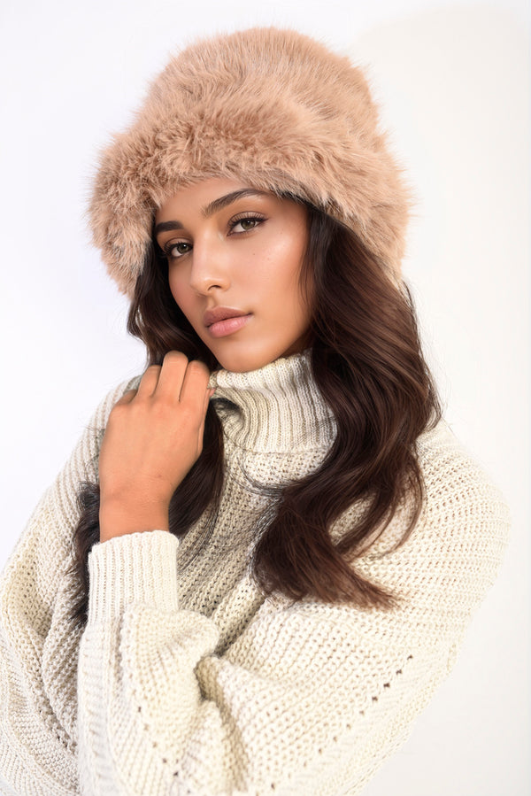 Woman wearing Ashley Fluffy Faux Fur Winter Hat and white sweater, showcasing a stylish, warm winter accessory from Holiday Clothes UK.