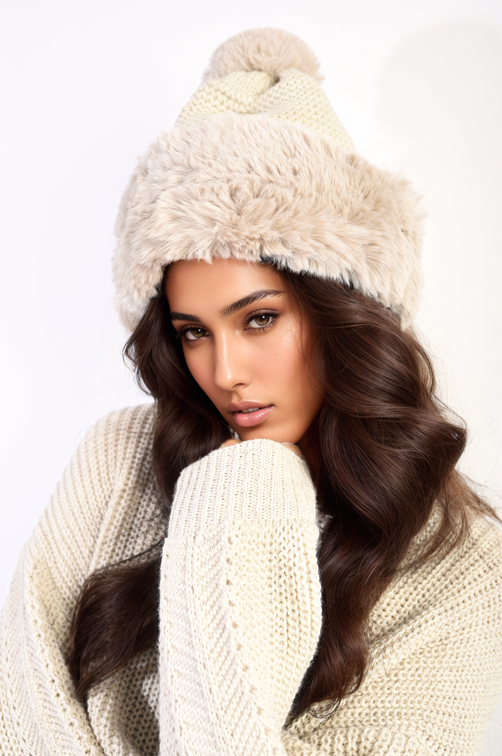 Woman wearing the Carly Faux Fur Knitted Winter Hat, showcasing its warm faux fur lining and chic knitted design, perfect for stylish winter outings.