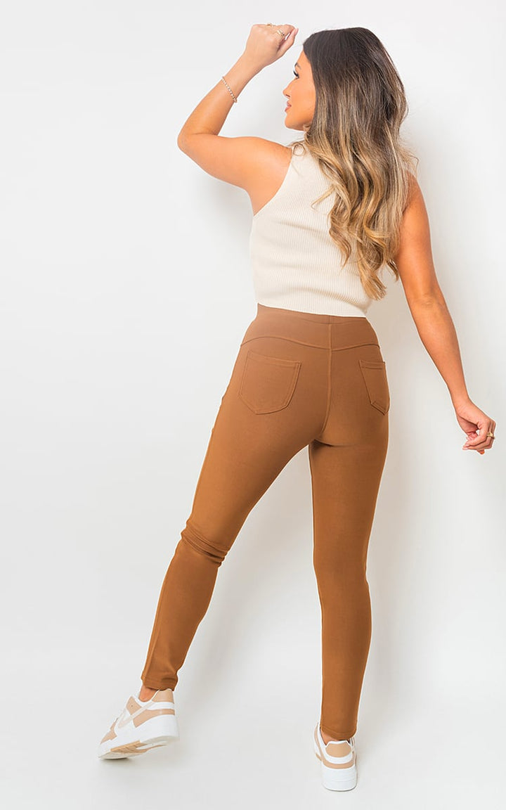 Woman modeling High Waist Double Band Pocket Leggings, showcasing a flattering fit with functional side pockets, ideal for style and comfort during workouts.