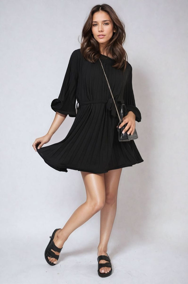 Pleated Tie Waist Mini Dress on model, showcasing its elegant silhouette with a cinched waist and pleated texture, perfect for versatile styling.