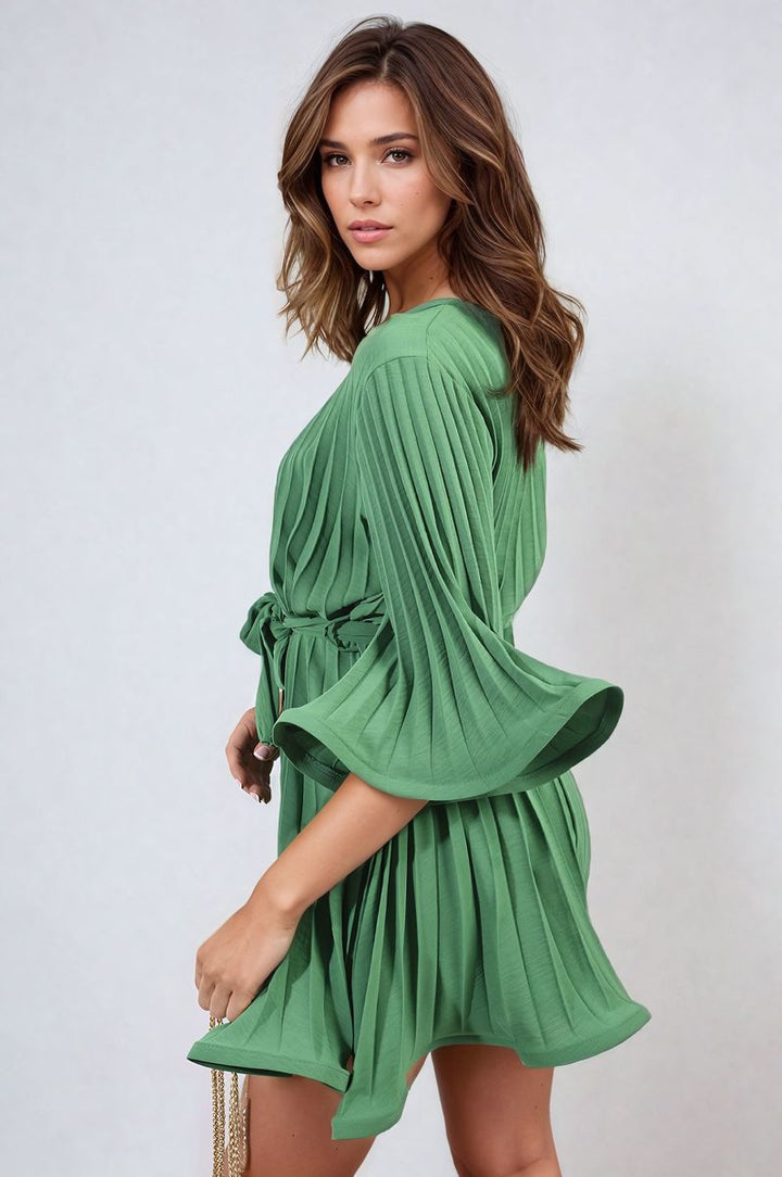 Pleated Tie Waist Mini Dress on model, showcasing its elegant pleating and tie waist design, perfect for stylish holiday and everyday wear. Shop online at Holiday Clothes UK.