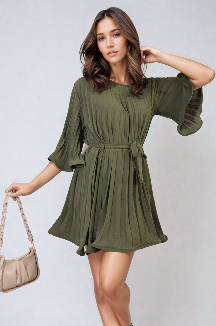 Pleated Tie Waist Mini Dress on model, highlighting its sophisticated pleating and tie waist design for a chic and flattering silhouette.