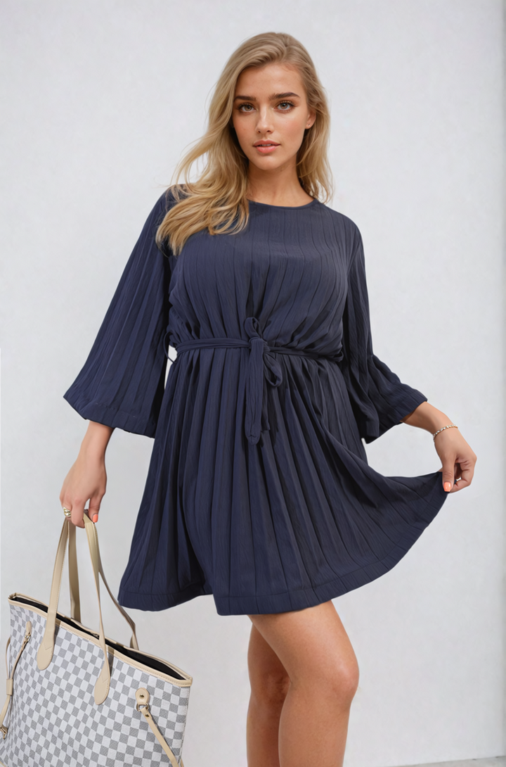 Pleated Tie Waist Mini Dress with sophisticated pleating and tie waist detail, perfect for various occasions. Ideal for stylish holiday and everyday wear.