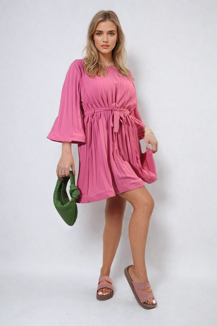 Woman in a Pleated Tie Waist Mini Dress holding a purse, showcasing elegant style and flattering fit, perfect for various occasions.