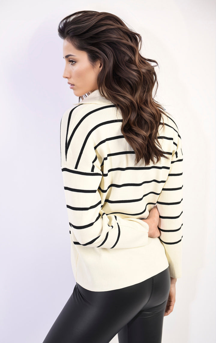 Woman wearing the Cecelia Striped Knitted Jumper, showcasing its relaxed fit and vibrant stripes, ideal for casual or polished looks.