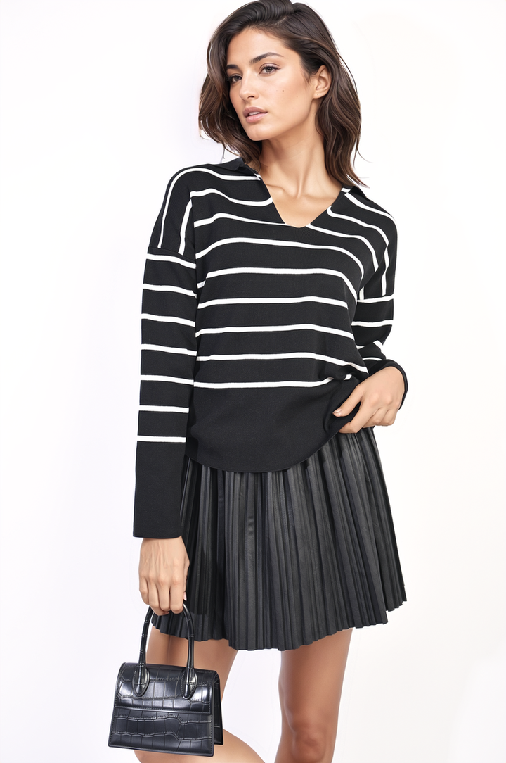 Striped Knitted Jumper: Woman in stylish black and white striped jumper, showcasing its relaxed fit and cozy texture, ideal for casual or polished looks.