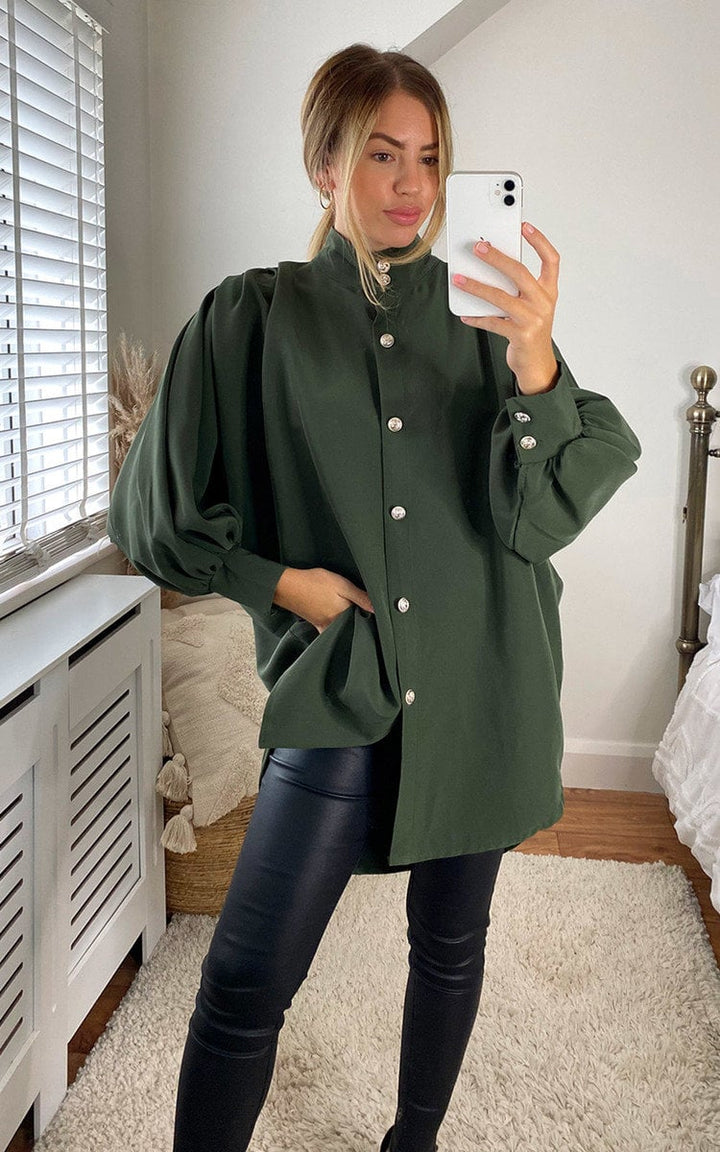 Woman wearing an Oversized High Neck Shirt, taking a selfie. The shirt features a relaxed fit, ideal for casual or sophisticated styles.