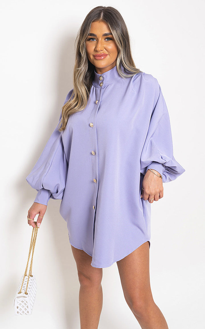 Oversized High Neck Shirt, featuring a relaxed fit, modeled with a white purse. Perfect for casual or sophisticated looks. Available at Holiday Clothes UK.