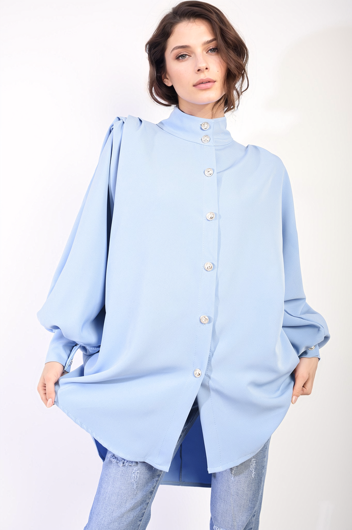 Oversized High Neck Shirt: Woman modeling a relaxed-fit blouse, highlighting its comfortable fabric and versatile style, perfect for casual or sophisticated looks.