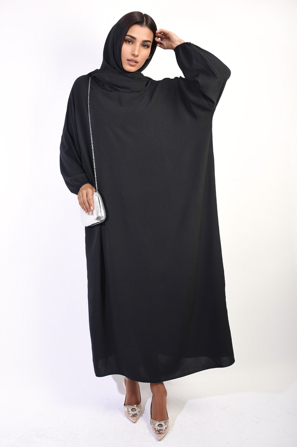 Woman wearing Long Sleeve Closed Abaya Maxi Dress, showcasing modest design with flowing silhouette and long sleeves, emphasizing elegance and sophistication. Scarf included.