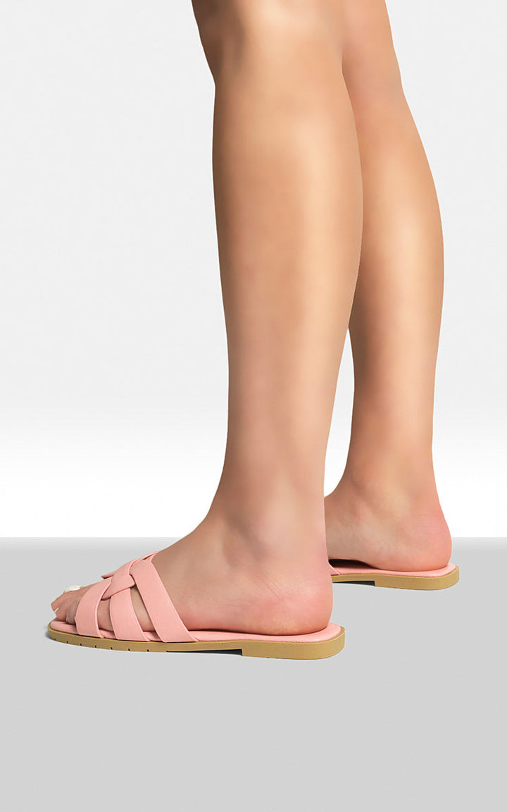 Close-up of a person's feet wearing Dana Faux Leather Flat Casual Sandals, showcasing their flexible design and comfort on a casual stroll.