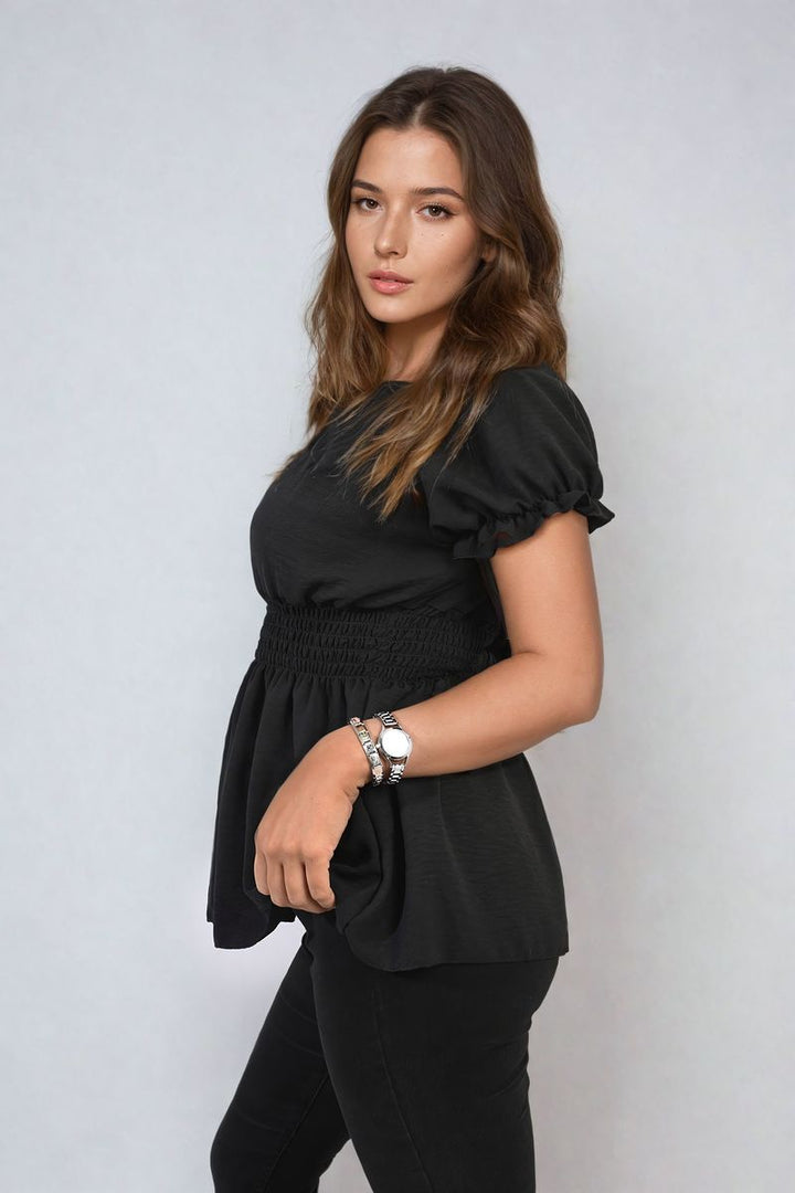 Woman modeling the Daniela Button Front Cinched Waist Top, showcasing its flattering fit and stylish button details. Ideal for versatile, chic holiday or everyday wear.