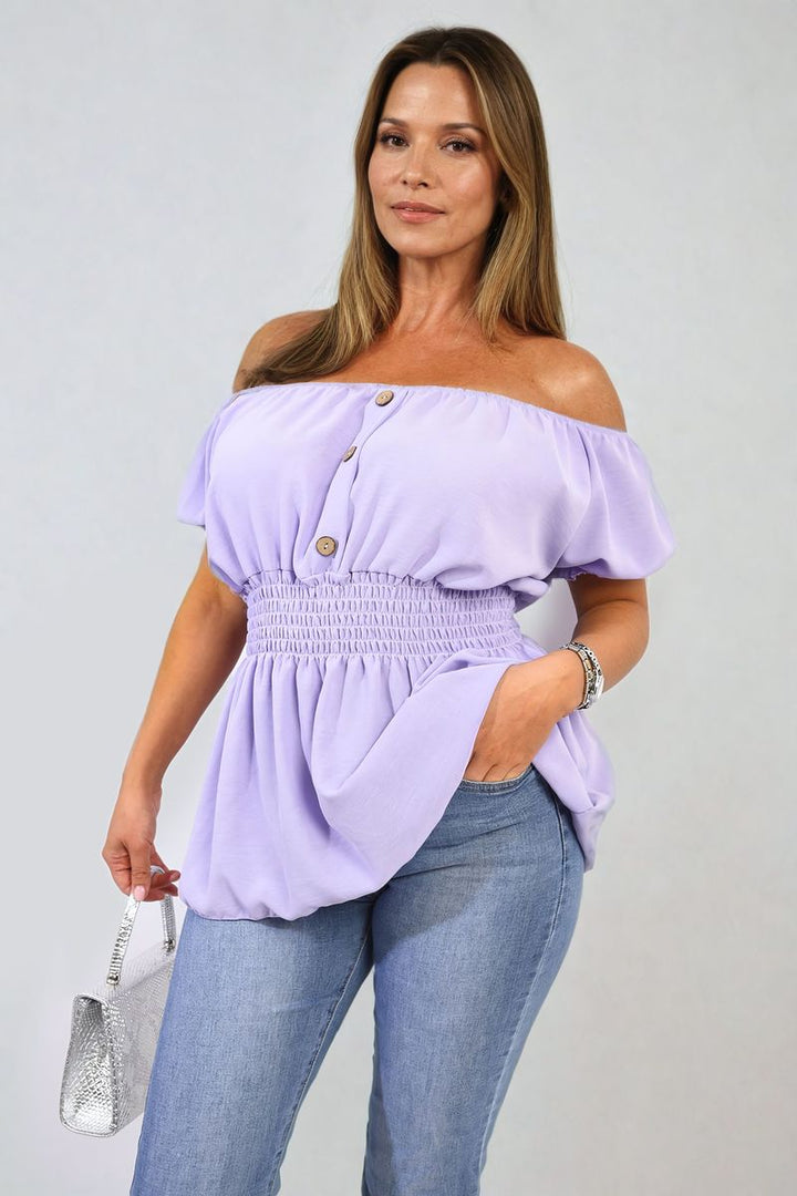 Woman wearing the Daniela Button Front Cinched Waist Top and blue jeans, holding a silver purse, showcasing a chic, versatile style from Holiday Clothes UK.