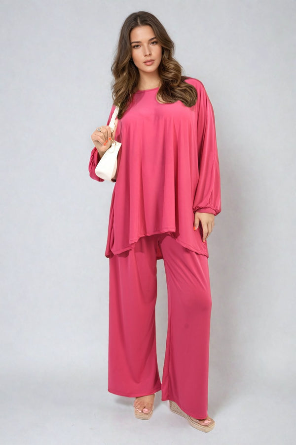 Woman wearing an oversized long sleeve top and wide leg co-ord set, showcasing relaxed yet chic fashion suitable for various occasions.