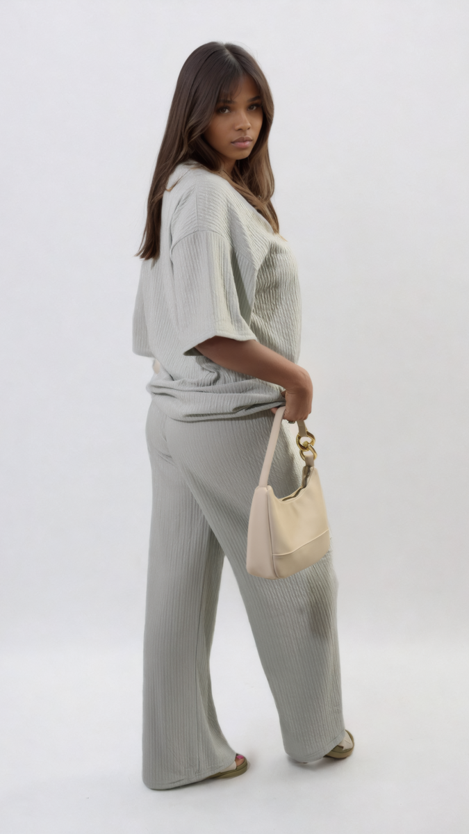 Woman in white Ribbed Oversized Top and Drawstring Wide Leg Trouser Co-ord Set, casually holding a purse.