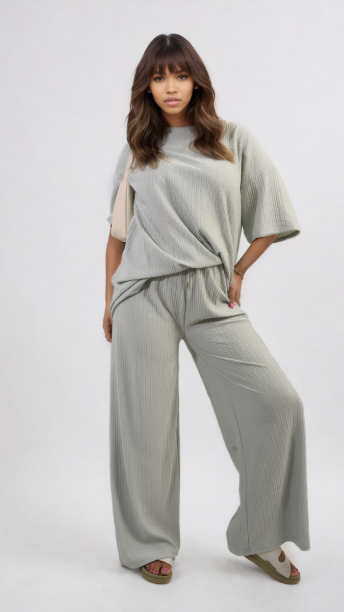 Woman wearing the Daniela Ribbed Oversized Top and Drawstring Wide Leg Trouser Co-ord Set, showcasing its relaxed, stylish fit in a casual pose.