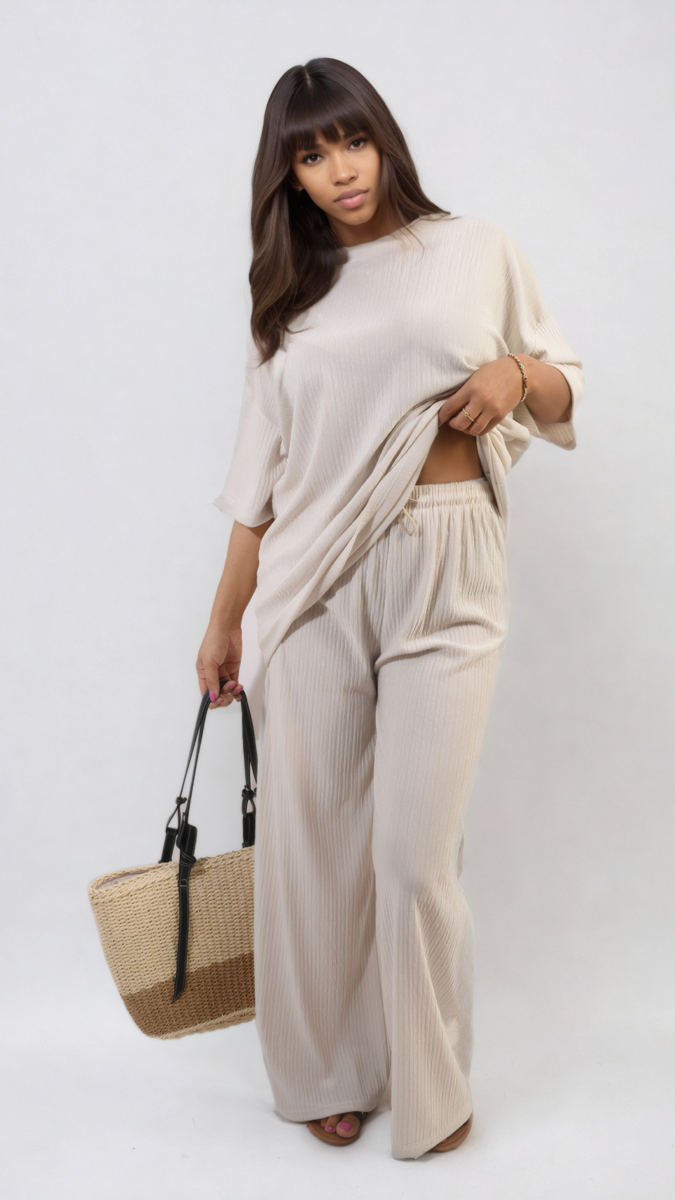 Woman in Ribbed Oversized Top and Drawstring Wide Leg Trouser Co-ord Set, holding a handbag, showcasing a stylish, comfortable look.