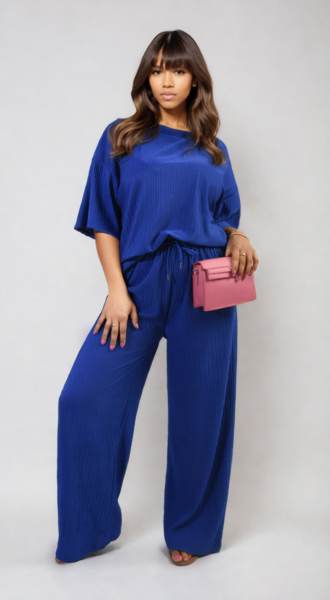 Woman wearing Ribbed Oversized Top and Drawstring Wide Leg Trouser Co-ord Set, holding a pink purse, embodying cozy and stylish fashion.