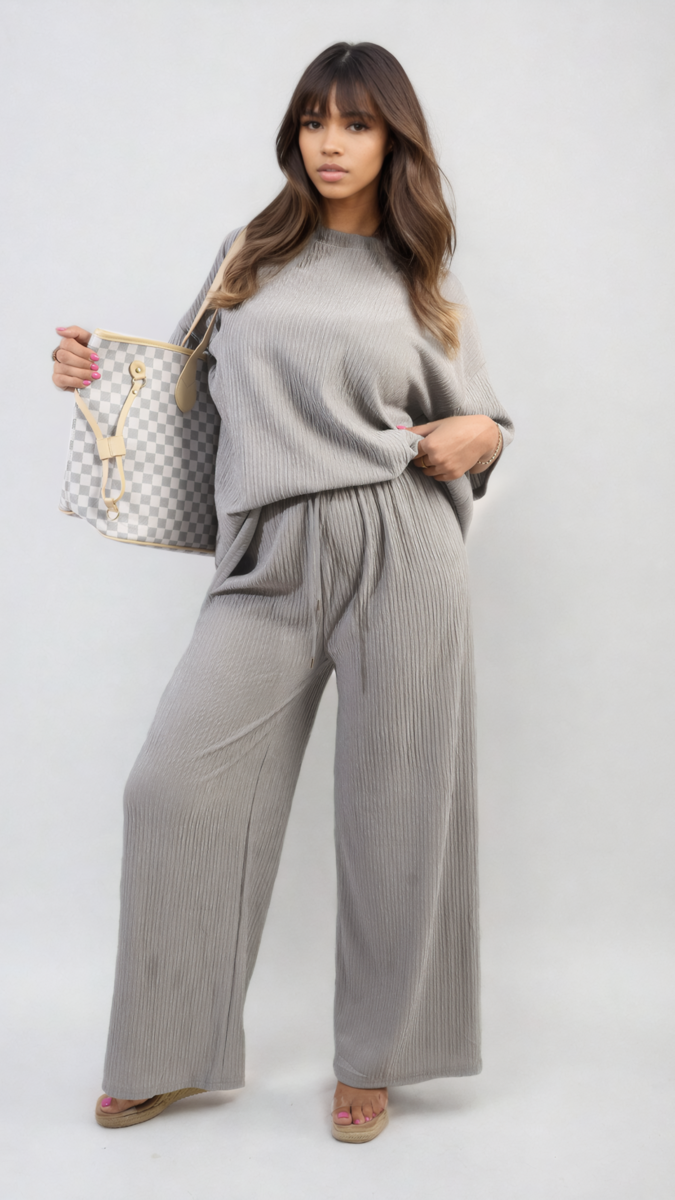 Woman holding Ribbed Oversized Top and Drawstring Wide Leg Trouser Co-ord Set, showcasing the comfortable and stylish design perfect for casual and chic wear.