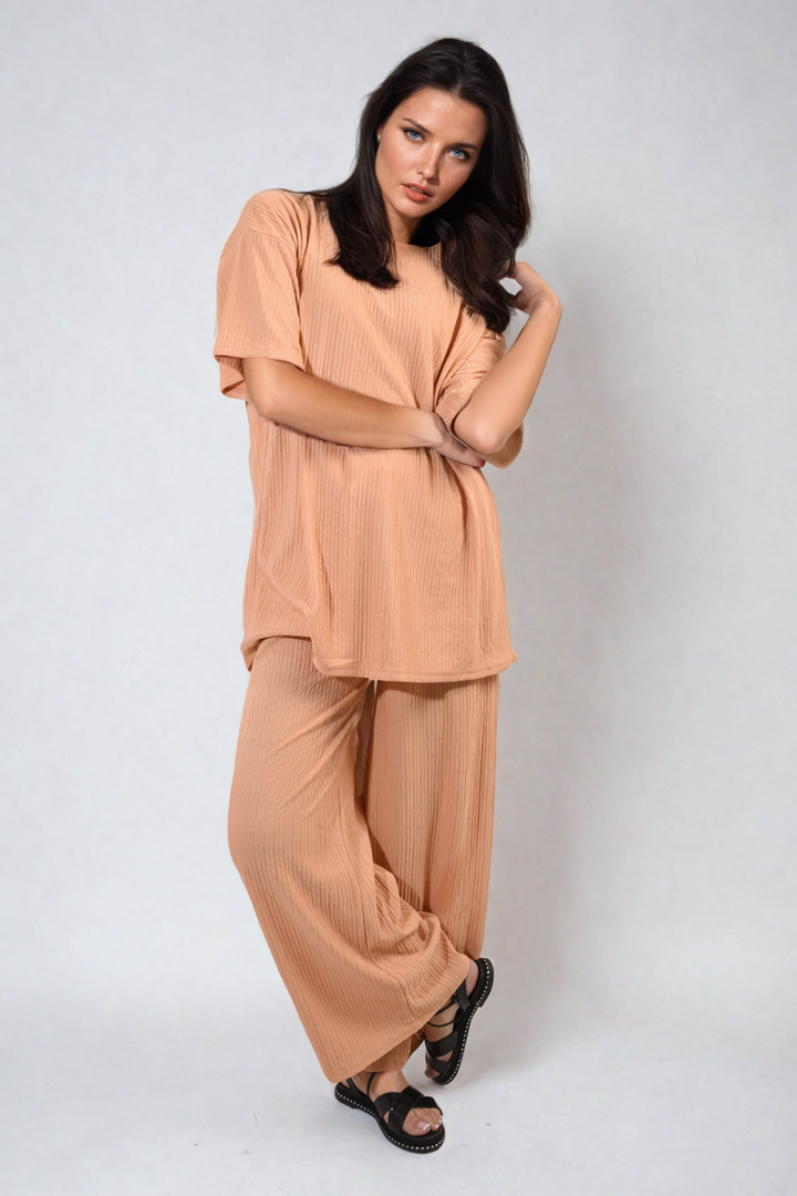 Woman modeling the Ribbed Oversized Top and Drawstring Wide Leg Trouser Co-ord Set, showcasing a comfy chic style for laid-back yet stylish days.