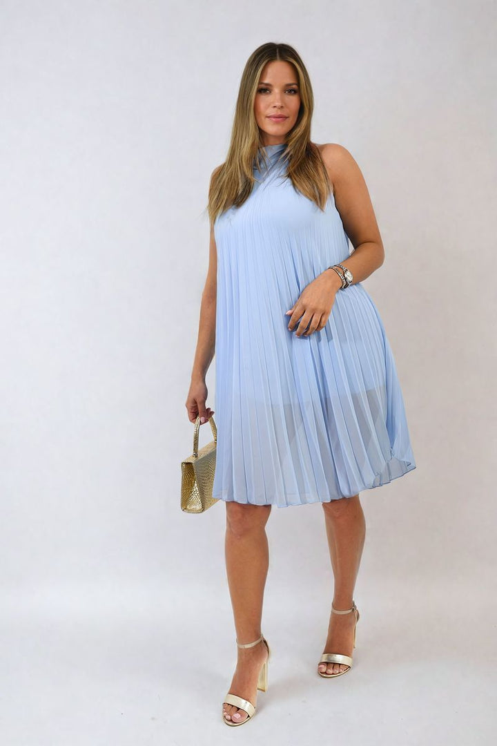 Woman in a blue Pleated Halter Neck Mini Dress holding a gold purse, showcasing a stylish and elegant fashion choice from holiday-clothes.co.uk.