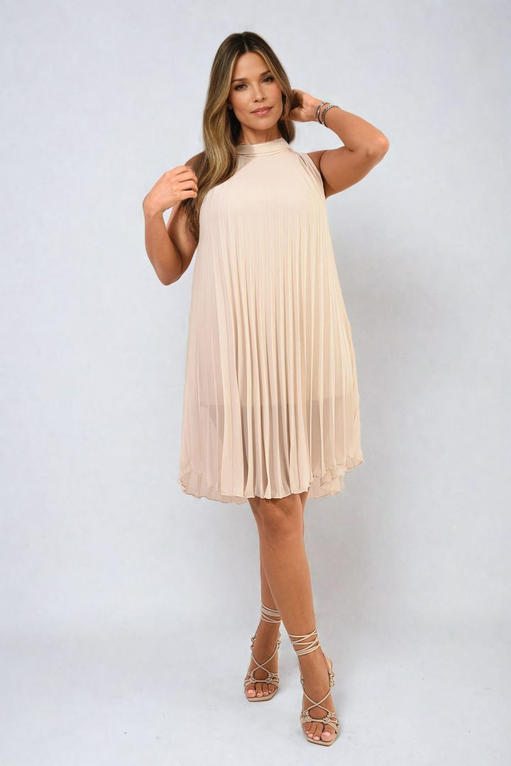 Woman modeling the Davina Pleated Halter Neck Mini Dress, showcasing its elegant pleats and halter neckline, perfect for stylish holiday occasions.