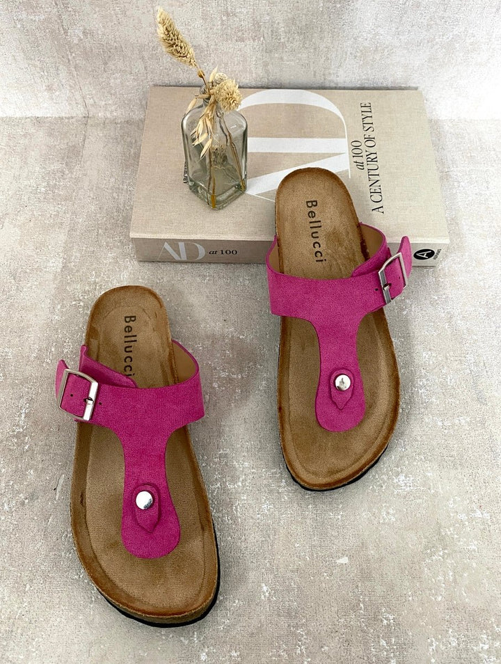 Pink T-strap Slip On Flat Thong Sandals beside a box, highlighting their minimalist design and cushioned footbed for stylish summer comfort.