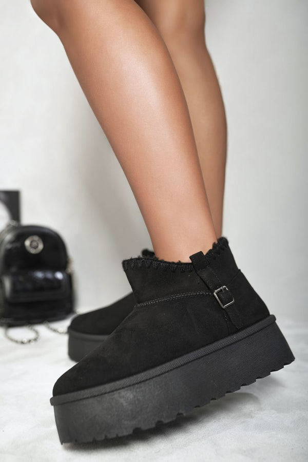 Fur-lined Platform Ankle Boots shown on feet, highlighting their chunky platform sole and snug fur lining, ideal for stylish warmth on chilly days.