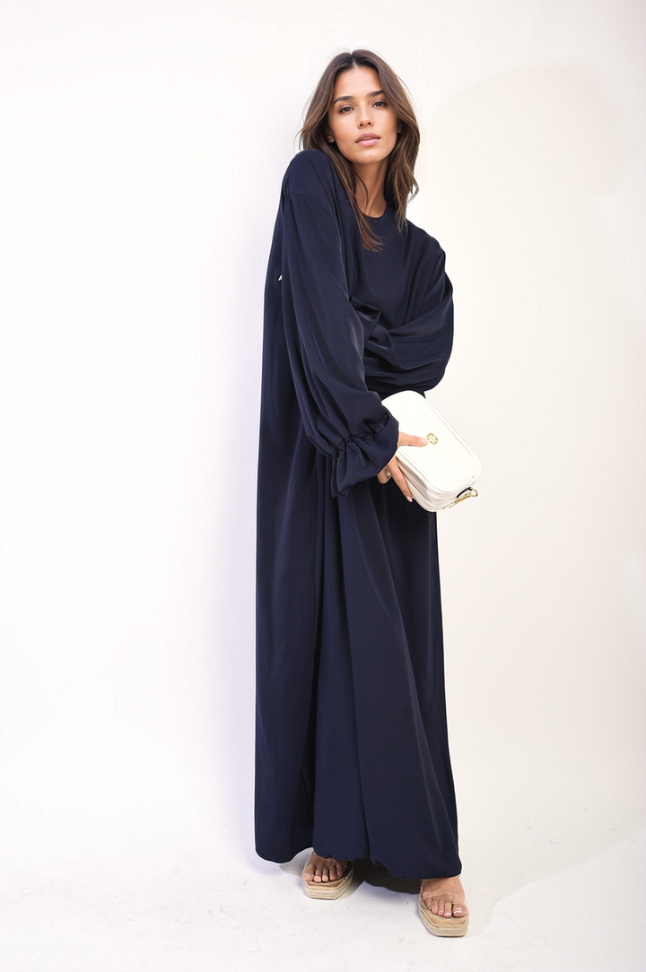 Woman in an Abaya Maxi Dress with Elastic Sleeve, showcasing elegant design and flowing silhouette, perfect for stylish holiday and everyday wear.