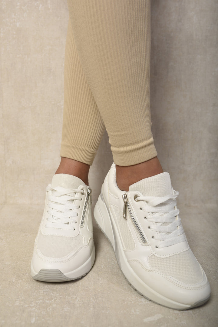 Side Zip Lace Up Wedge Trainers with a stylish design, showcasing a close-up of the shoes worn, highlighting the lace-up and side zip features.