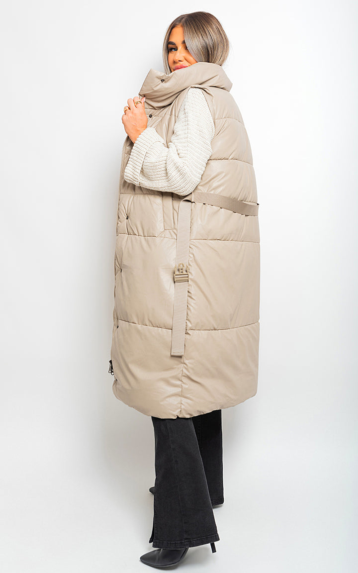 Belted Long Puffer Gilet on model; stylish, cozy outerwear with waist belt, ideal for layering and winter fashion. Perfect for UK holiday clothing needs.