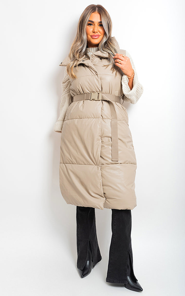 Woman wearing Dorothy Belted Long Puffer Gilet, showcasing a stylish belted design and long puffy silhouette for warmth and sophistication.