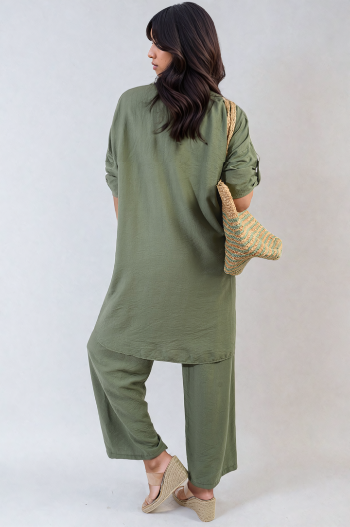 Woman wearing Oversized Button Front Shirt & Wide Leg Pants Co-ord Set, holding a straw handbag, showcasing a comfortable and stylish outfit perfect for relaxed days.