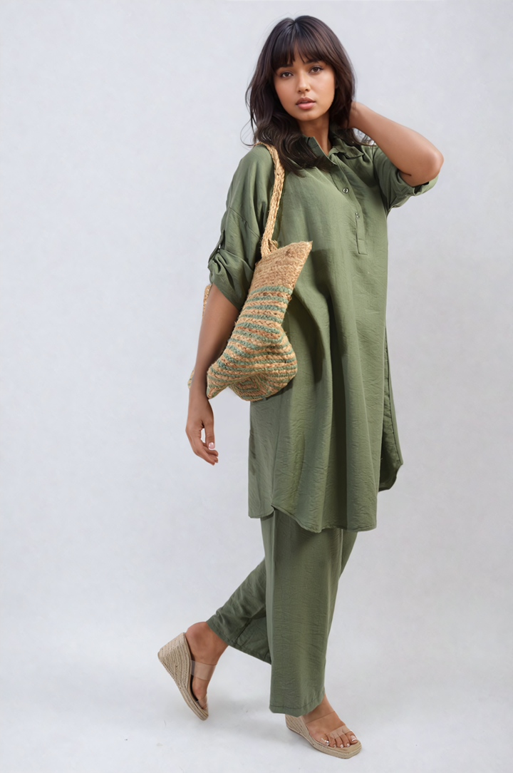 Woman in Oversized Button Front Shirt & Wide Leg Pants Co-ord Set holding a straw bag, showcasing a relaxed, stylish look ideal for casual outings.