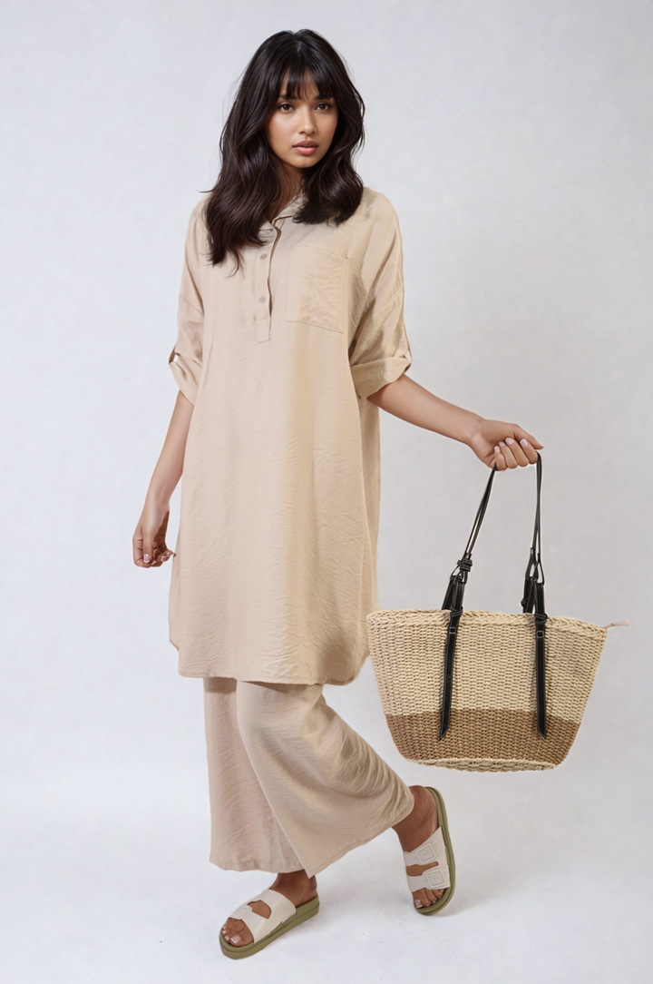 Woman showcasing the Dulce Oversized Button Front Shirt & Wide Leg Pants Co-ord Set, highlighting its comfortable and stylish design for a relaxed, everyday look.