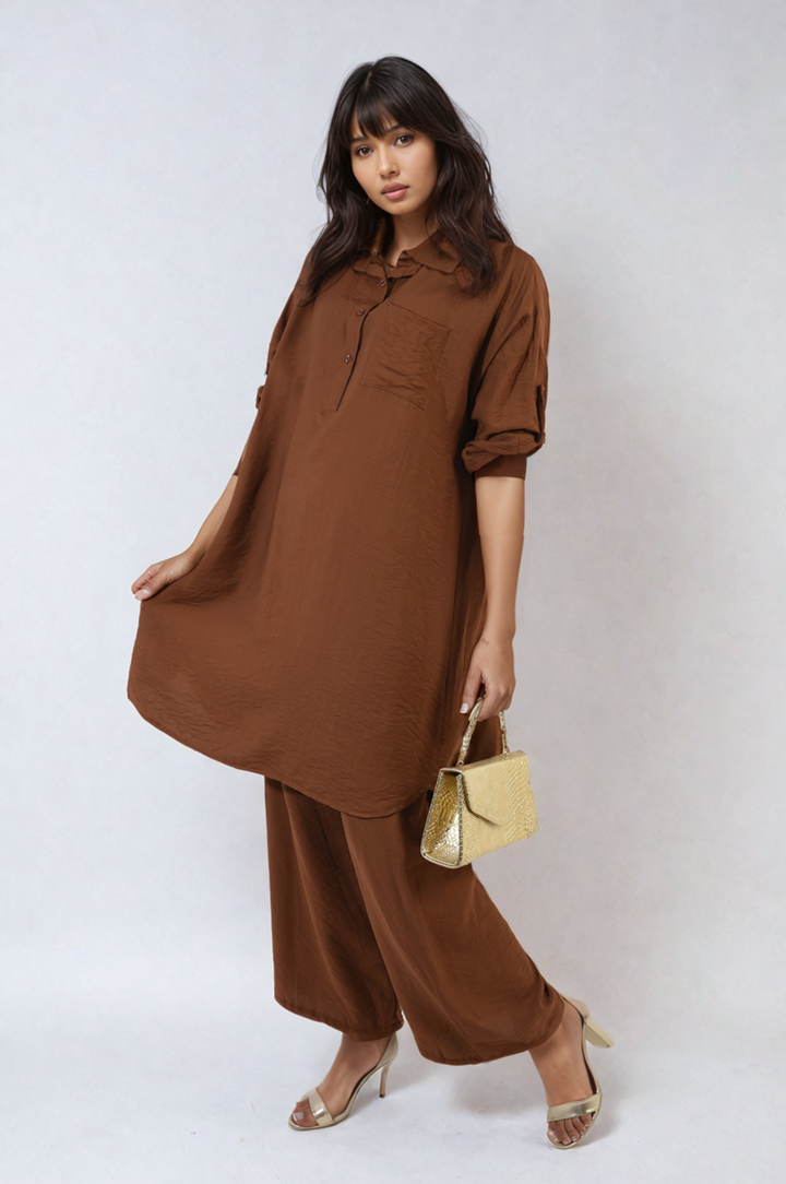 Woman wearing an Oversized Button Front Shirt & Wide Leg Pants Co-ord Set, holding a gold purse, showcasing a relaxed, stylish outfit from Holiday Clothes UK.