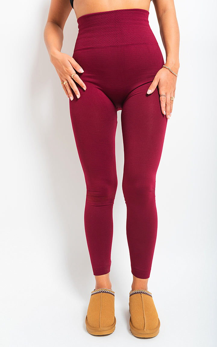 Woman wearing High Waist Tummy Compression Slimming Leggings - Big Size, showcasing their high waistband and supportive fit, paired with brown slippers.