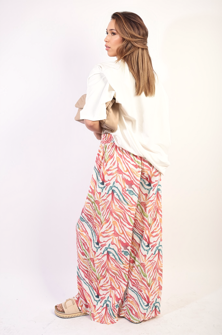 Woman wearing Elaine Pleated Wide Leg and Elastic Waist Trousers, showcasing a stylish, comfortable fit ideal for both casual and formal occasions.