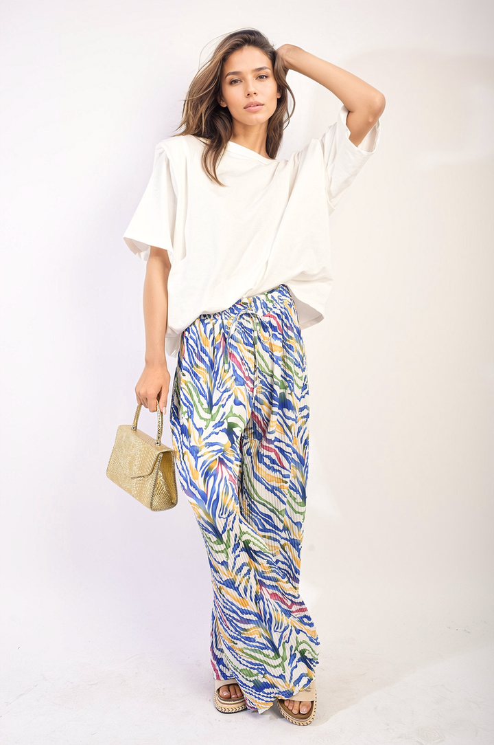 Woman wearing Pleated Wide Leg and Elastic Waist Trousers, showcasing the relaxed fit and elegant pleats, ideal for both casual and formal occasions.