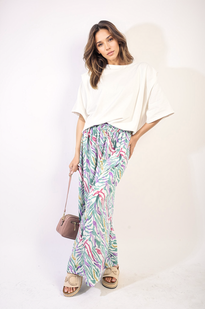 Woman wearing Elaine Pleated Wide Leg and Elastic Waist Trousers, showcasing a sophisticated, comfortable design ideal for casual or formal occasions.